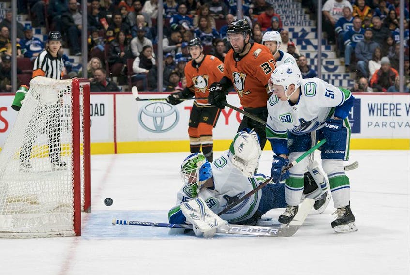 Anaheim Ducks forward Nick Ritchie (37) and Vancouver Canucks defenceman Troy Stecher (51) look on as Anaheim Ducks forward Adam Henrique (14) scores on Vancouver Canucks goalie Thatcher Demko (35) at Rogers Arena recently.
