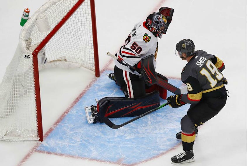Aug 11, 2020; Edmonton, Alberta, CAN; Vegas Golden Knights right wing Reilly Smith (19) scores a goal past Chicago Blackhawks goaltender Corey Crawford (50) during the third period in game one of the first round of the 2020 Stanley Cup Playoffs at Rogers Place. Mandatory Credit: Perry Nelson-USA TODAY Sports ORG XMIT: USATSI-429679