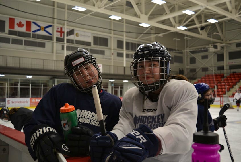 Carly Gould, left, of We'koqma'q and Nevaeh Doucette of Membertou were joking around on the ice at the Membertou Sport and Wellness Centre. They're both new to hockey and participating in the Female Indigenous Hockey Program taking place in three communities – Membertou, Eskasoni and Truro. It's the second year for Hockey Nova Scotia's pilot program aimed at bringing more opportunities for Indigenous girls to join hockey.  ARDELLE REYNOLDS/CAPE BRETON POST