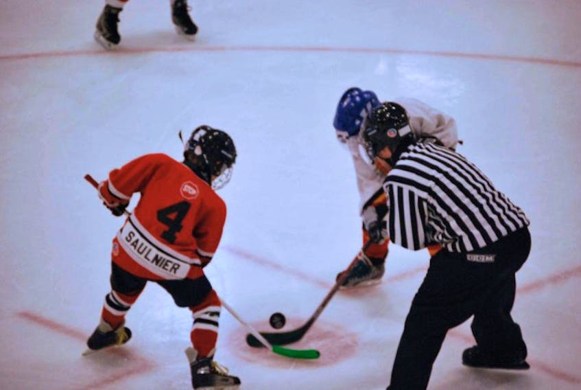Hayden Saulnier, player with the Liverpool Cougars Atom Division, faces off against the Shelburne Flames at the Jack Frost Christmas hockey tournament at Queens Place in Liverpool on Dec. 28.