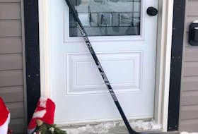 On many porches across Newfoundland and Labrador today a hockey stick is an expression of sympathy for the family of the 10 year old from Clarenville who died tragically on Christmas Day.