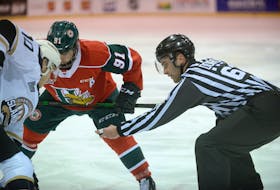 Linesman Tanner Doiron, right, prepares to drop the puck during a faceoff between Charlottetown Islanders centre Brett Budgell, left, and Halifax Mooseheads centre Elliot Desnoyers during a recent Quebec Major Junior Hockey League game at the Eastlink Centre.