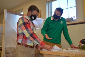 Matthias Brennan, right, a student in Holland College’s heritage retrofit carpentry program, asks the program’s learning manager, Josh Silver, a question during the first day back in class on Tuesday.

