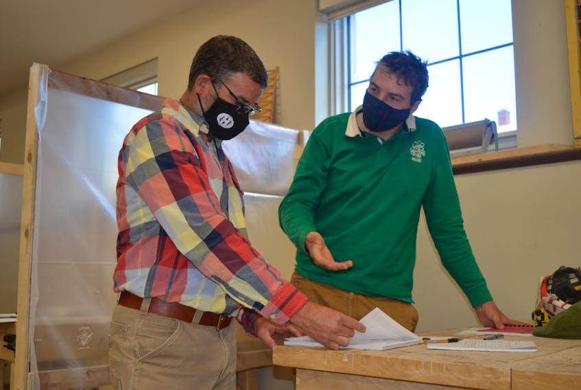 Matthias Brennan, right, a student in Holland College’s heritage retrofit carpentry program, asks the program’s learning manager, Josh Silver, a question during the first day back in class on Tuesday.

