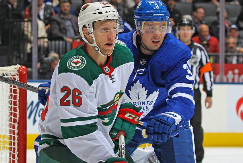 Maple Leafs' Justin Holl (right) is eager to get into the lineup against the Boston Bruins on Saturday. (GETTY IMAGES)