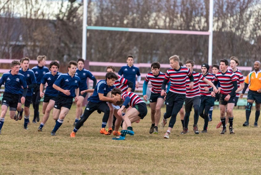 Holy Spirit Falcons (striped jerseys) and the Gonzaga Vikings clash in the final of the St. John’s Boys Tier 1 High School Rugby League this week at the Swilers Rugby Club complex in St. John’s. Holy Spirit won 29-5. – Mark Sexton photo