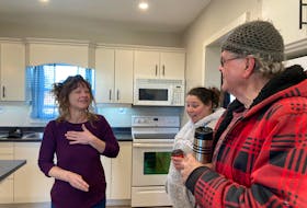Heather Nickerson places her hand over her heart in thanking Alex Blooi and Laura Jeddry for their part in transforming her family's home. CARLA ALLEN • TRICOUNTY VANGUARD