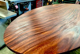 Thorough sanding of a table top is usually the first step to renewing a finish. Wax contaminants can sometimes still remain on a surface like this after sanding. Cleaning with rubbing alcohol and a rag gets rid of these contaminants without leaving a residue behind.