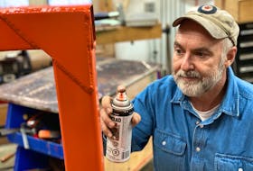 Steve Maxwell applies rust paint to a newly made metal item in his shop. With a little bit of prep work, today’s best metal paints do not peel. 