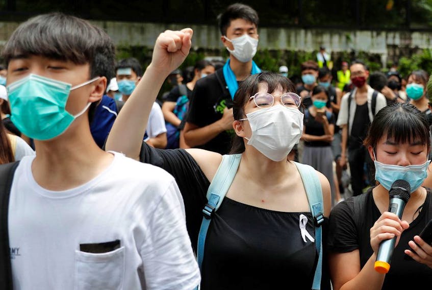 Protesters chant slogans outside the Department of Justice during a demonstration demanding that Hong Kong's leaders step down.