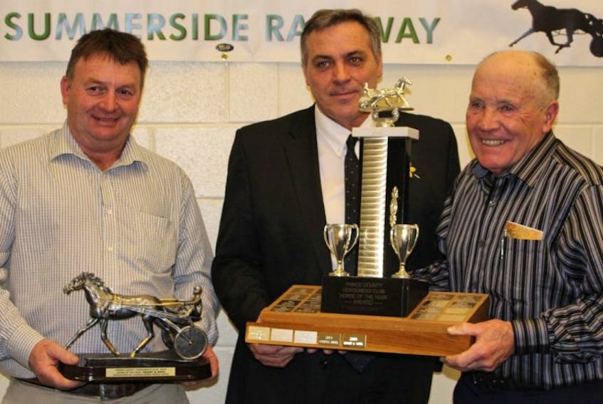 <p>George Riley, right, accepts his trophy from Robert Mitchell, centre, the minister responsible for harness racing on P.E.I., and Garth Cole, president of the Prince County Horsemen’s Club, after his two-year-old record-breaking colt, Heart and Soul, was named Horse of the Year during the club’s annual awards night.&nbsp;</p>