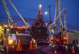 Nova Scotia Power crews work to string lights on the Christmas tree in front of the Aberdeen Hospital. 