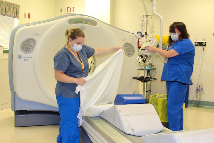 Kim LeBlanc, left, and Jacqueline Townsend, both computed tomography technologists at the Cape Breton Regional Hospital in Sydney, prepare the CT scanner for their next patient. Lynn Gilbert/NSHA
