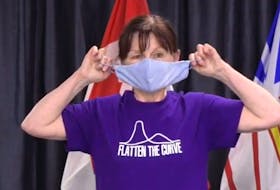 Infection control nurse specialist Brenda Earles of Health and Community Services shows how to remove or wear a cloth face mask without touching the front. Image from video