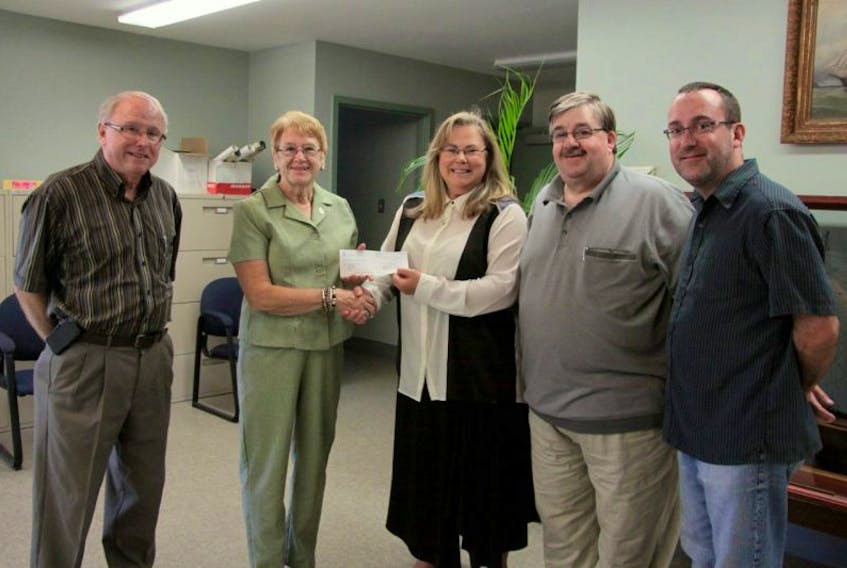 <p>From left, West Hants Warden Richard Dauphinee, Shirley Pineo, Margot Bureaux, Harold Bulger and Hantsport Mayor Robbie Zwicker were all smiles after West Hants presented a cheque for $15,000 to assist the town in their efforts to relocate the public library.</p>