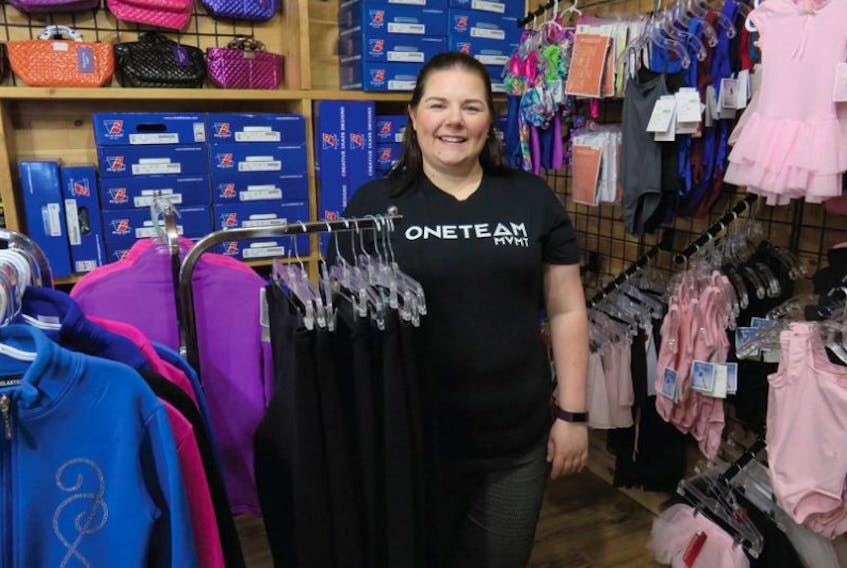 Carolyn Walsh is owner/operator of High Performance Sports Equipment in Conception Bay South.  She is shown here in a display of dance and gymnastics costumers, including sweaters for figure skating and Kiss-And-Cry bags.