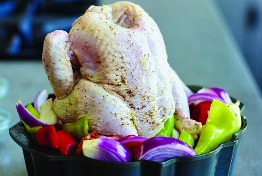  Using a Bundt pan as a vertical roaster allows the chicken to get brown and crisp all around and its juices to moisten the vegetables below. Photo courtesy of John Kernick.
