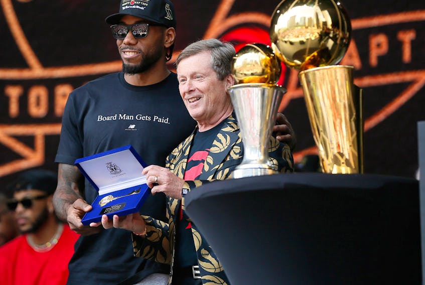 Kawhi Leonard accepts the key to the city from Toronto mayor John Tory after the Raptors won the NBA Championships.