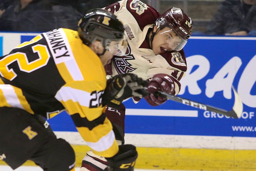 Peterborough Petes Nick Robertson, right,  gets a shot off past Kingston Frontenacs defenceman Jakob Brahaney during Ontario Hockey League action at the Leon's Centre in Kingston on Friday Jan. 4, 2019. (Ian MacAlpine/The Whig-Standard/Postmedia Network)