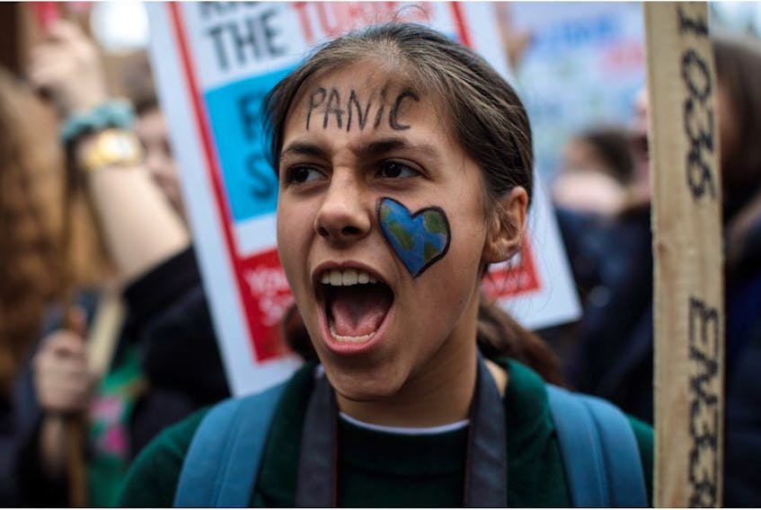  A girl wears face paint as schoolchildren take part in a student climate protest on March 15, 2019 in London, England.