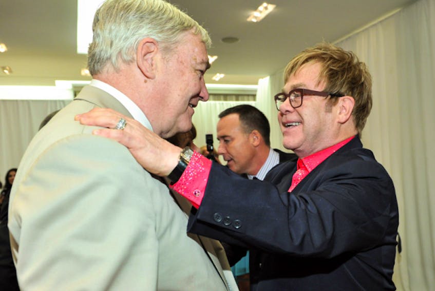  Conrad Black is greeted by Sir Elton John in Holt Renfrew in Toronto in 2012. The pop star was one of the celebrities who vouched for Black’s character.