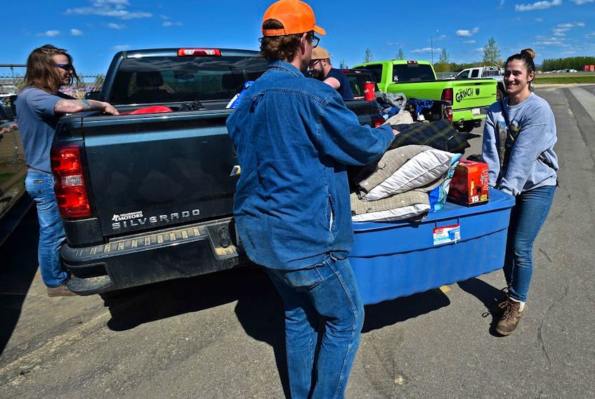  Some of the 4000 High Level evacuees from the Chuckegg Creek fire, like Mathew Blaney and Courtanne Bolduc loading up possessions which they managed to get from there homes in the parking lot of the Legacy Centre where evacuees are registering in Slave Lake, May 21, 2019.