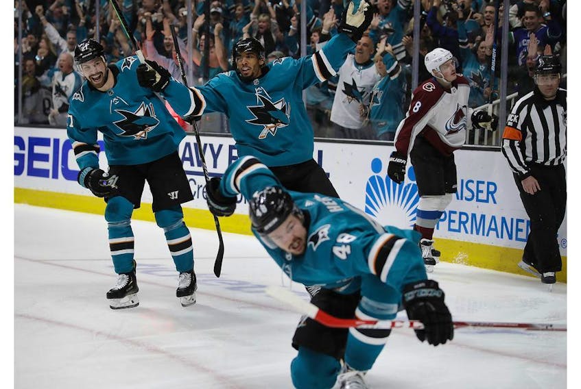 San Jose Sharks' Joonas Donskoi, left, and Evander Kane celebrate a goal by Tomas Hertl (48) during the third period of Game 5 of the team's NHL hockey second-round playoff series against the Colorado Avalanche on Saturday, May 4, 2019, in San Jose, Calif.