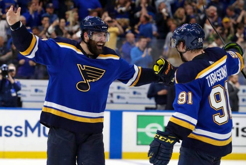 Blues left wing Pat Maroon (left) and right wing Vladimir Tarasenko (right) celebrate the team's 2-1 win against the Stars in double overtime in Game 7 of an NHL second-round playoff series in St. Louis on Tuesday, May 7, 2019.