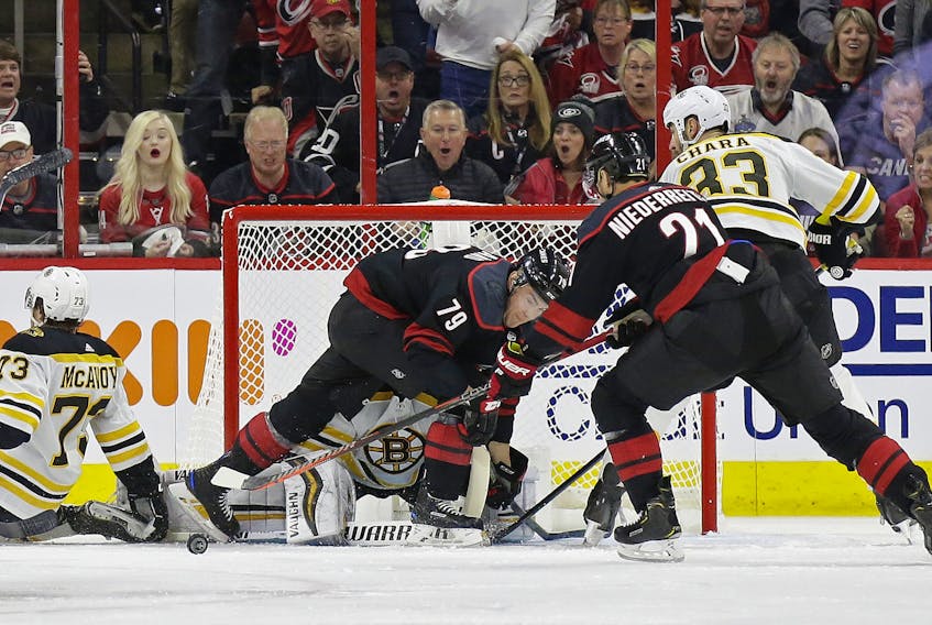  Carolina Hurricanes’ Micheal Ferland and Nino Niederreiter try to score on Boston Bruins goalie Tuukka Rask during the first period in Game 3 of their Eastern Conference final series on Tuesday in Raleigh, N.C.