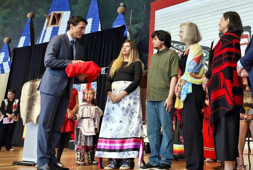 Prime Minister Justin Trudeau is presented with the final report during the closing ceremony of the National Inquiry into Missing and Murdered Indigenous Women and Girls in Gatineau, Que., on June 3.