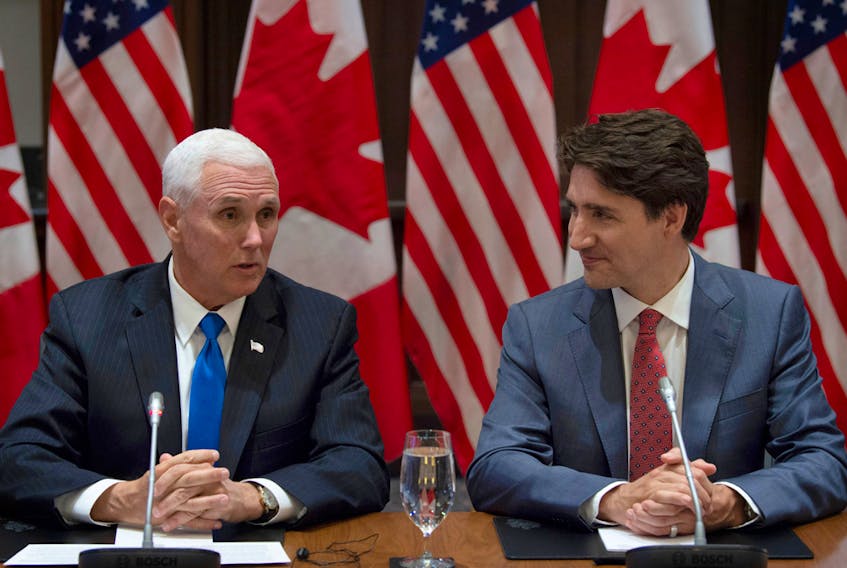 Prime Minister Justin Trudeau listens as U.S. Vice-President Mike Pence makes opening remarks at the Canadian Council for the USMCA on Parliament Hill.