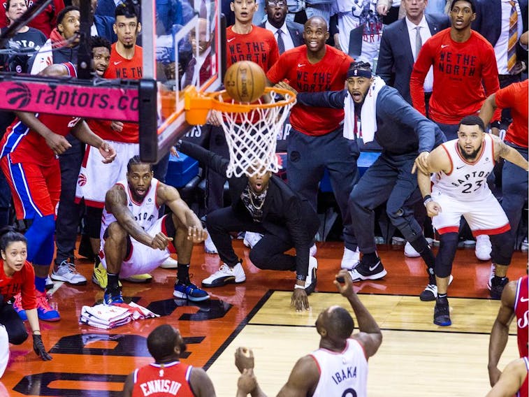 Kawhi Leonard, squatting at left, watches as his game-winning ball goes in, to clinch the series in Game 7, as the Toronto Raptors defeat the Philadelphia 76ers, in Toronto on May 13, 2019. His performance in the game is typified by the hyper-concentration and exceptional effort exhibited when facing ambitious goals, Referred to as the clutch state, it’s best described as the ability to dig deep to achieve a goal or bust through a performance plateau.