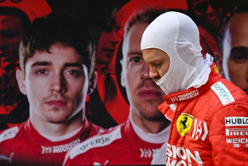Sebastian Vettel walks back to his pit garage past a poster showing Ferrari teammate Charles Leclerc during practice for the Chinese Grand Prix in April.