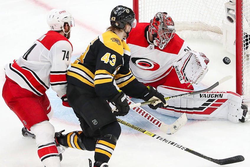 Danton Heinen of the Boston Bruins scores a third period goal against Petr Mrazek of the Carolina Hurricanes in Game 2 of the Eastern Conference Final during the 2019 NHL Stanley Cup Playoffs at TD Garden on May 12, 2019 in Boston.