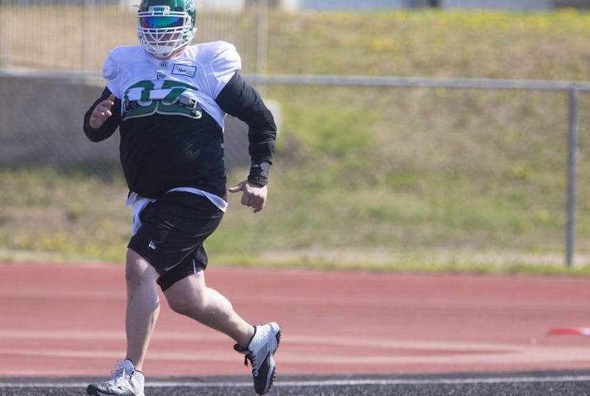Riders centre Dan Clark kept in shape while jogging in the end zone at Griffiths Stadium while recovering injuries sustained in a single-vehicle accident on May 7.