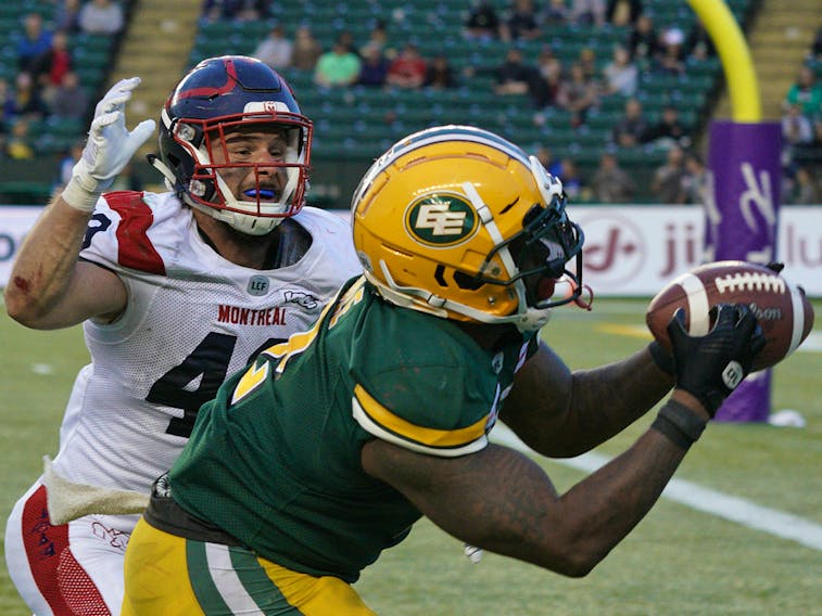 Edmonton Eskimos running back C.J. Gable eludes a tackle by Montreal Alouettes' Jean-Gabriel Poulin to make a touchdown reception at Commonwealth Stadium in Edmonton on Friday, June 14, 2019.