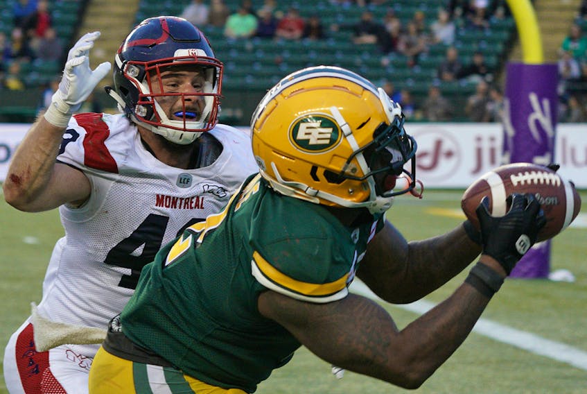 Edmonton Eskimos running back C.J. Gable eludes a tackle by Montreal Alouettes' Jean-Gabriel Poulin to make a touchdown reception at Commonwealth Stadium in Edmonton on Friday, June 14, 2019.