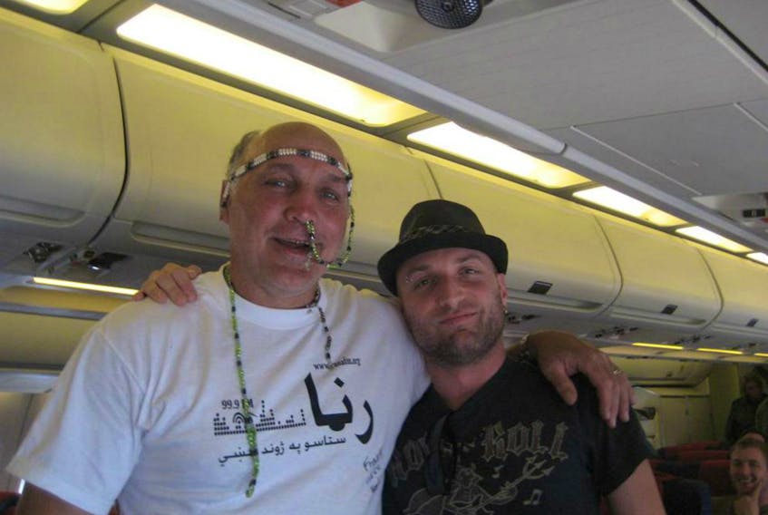 Former NHL player Dave 'Tiger' Williams, left, during an earlier 2010 military morale tour to Afghanistan with what appear to be beads stuck up his nose.