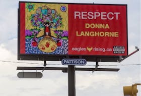 A billboard with art by Donna Langhorne, which is part of a national Artists Against Racism campaign to raise awareness for Missing and Murdered Indigenous Women and Girls in Canada, stands near the intersection of dylwyld Drive North and 23rd Street in Saskatoon, SK on Wednesday, June 19, 2019.