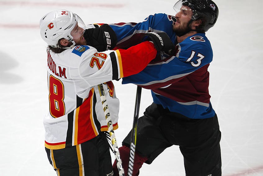 Calgary Flames center Elias Lindholm, left, fights with Colorado Avalanche center Alexander Kerfoot during the first period of Game 4 of an NHL hockey playoff series Wednesday, April 17, 2019, in Denver. (AP Photo/David Zalubowski) ORG XMIT: CODZ121