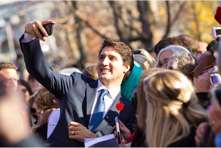 Prime Minister Justin Trudeau takes a selfie as he greets the crowd outside Rideau Hall after being sworn in as Canada's 23rd Prime Minister in Ottawa, Ontario, November 4, 2015.    AFP PHOTO/ GEOFF ROBINSGEOFF ROBINS/AFP/Getty Images