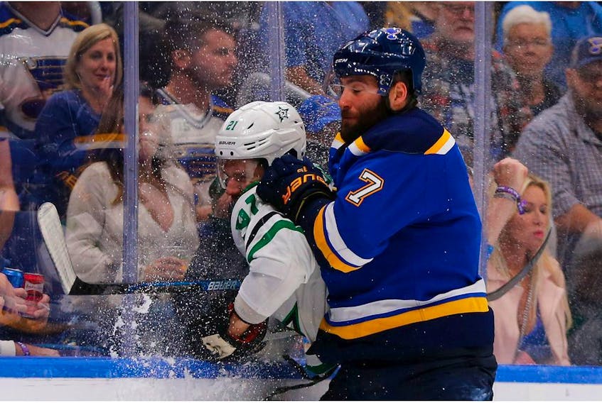 Blues forward Pat Maroon takes Stars counterpart Ben Lovejoy into the boards during Game 7 of the Western Conference Second Round playoff series at the Enterprise Center on Tuesday night in St. Louis.