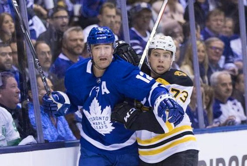 Toronto Maple Leafs centre Patrick Marleau and Boston Bruins defenceman Charlie McAvoy on the boards as the Toronto Maple Leafs take on the Boston Bruins in Game 3 in Toronto on Monday April 15, 2019. 