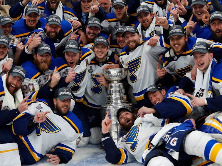 St. Louis Blues players pose for a team photo with the Stanley Cup after defeating the Boston Bruins in game seven of the 2019 Stanley Cup Final at TD Garden.