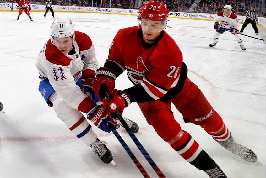  Hurricanes’ Sebastian Aho, right, battles Canadiens’ Brendan Gallagher for the puck in the corner during a game last December at the Bell Centre.