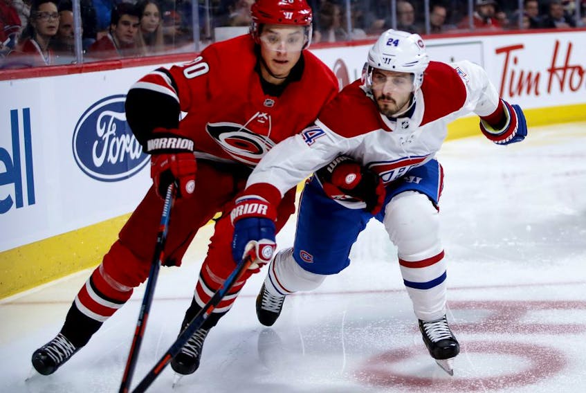 Canadiens centre Phillip Danault and Carolina Hurricanes centre Sebastian Aho battle for puck during NHL game at the Bell Centre in Montreal on Dec. 13, 2018. 