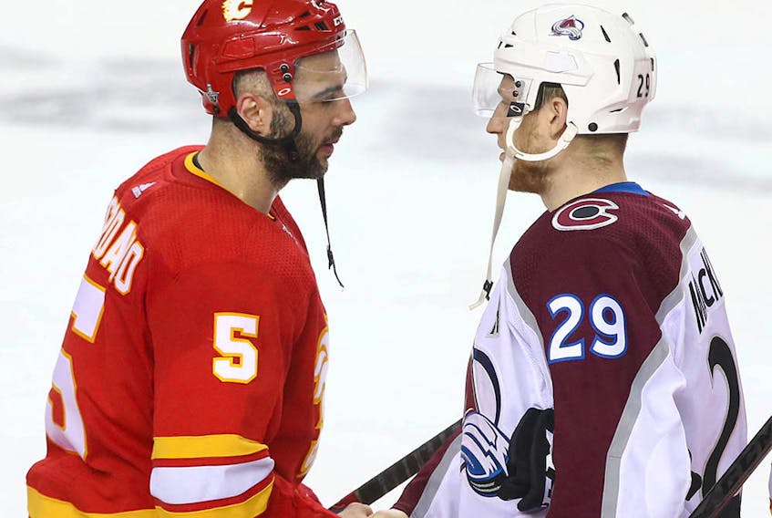 Flames Mark Giordano (L) shakes hands with Avalanche Nathan MacKinnon following game five between the Colorado Avalanche and Calgary Flames in Calgary on Friday, April 19, 2019. Jim Wells/Postmedia