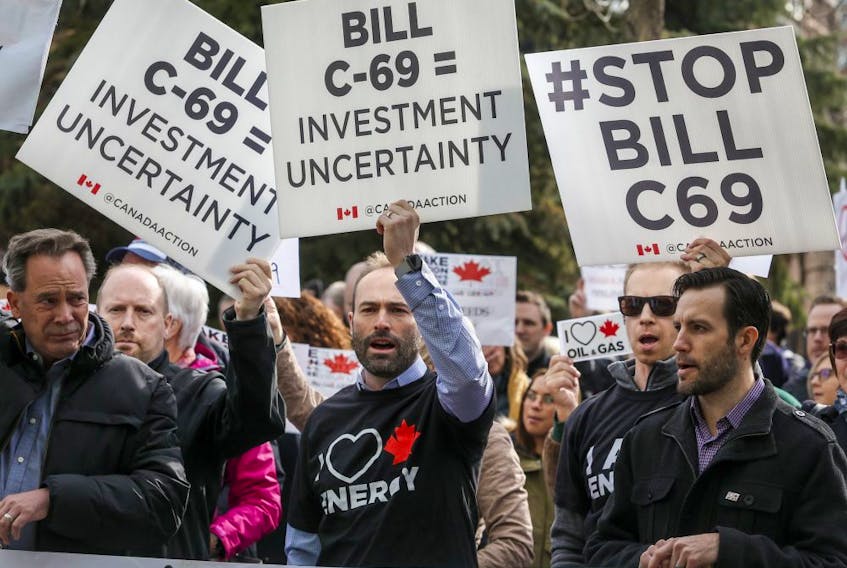 Pro-pipeline supporters rally outside a public hearing of the Senate Committee on Energy, the Environment and Natural Resources regarding Bill C-69 in Calgary, Alta., Tuesday, April 9, 2019. 