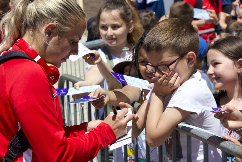 Canadian striker Adriana Leon signs an autograph following a training session at the Complexe Sportif de Laverune in Laverune, France on Thursday June 6, 2019. Canada open the FIFA 2019 Women's World Cup against Cameroon on Monday in Montpellier, France.  
