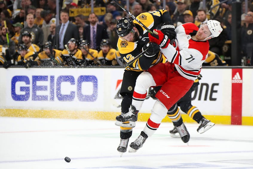 Bruins forward David Backes (left) checks Lucas Wallmark  of the Carolina Hurricanes during their Eastern Conference final. Boston swept the series 4-0. (Bruce Bennett/Getty Images)